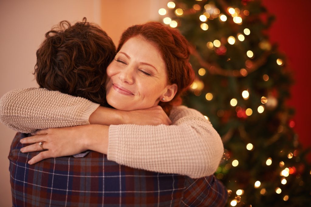 Christmas hug. Shot of an affectionate young couple embracing at Christmas time