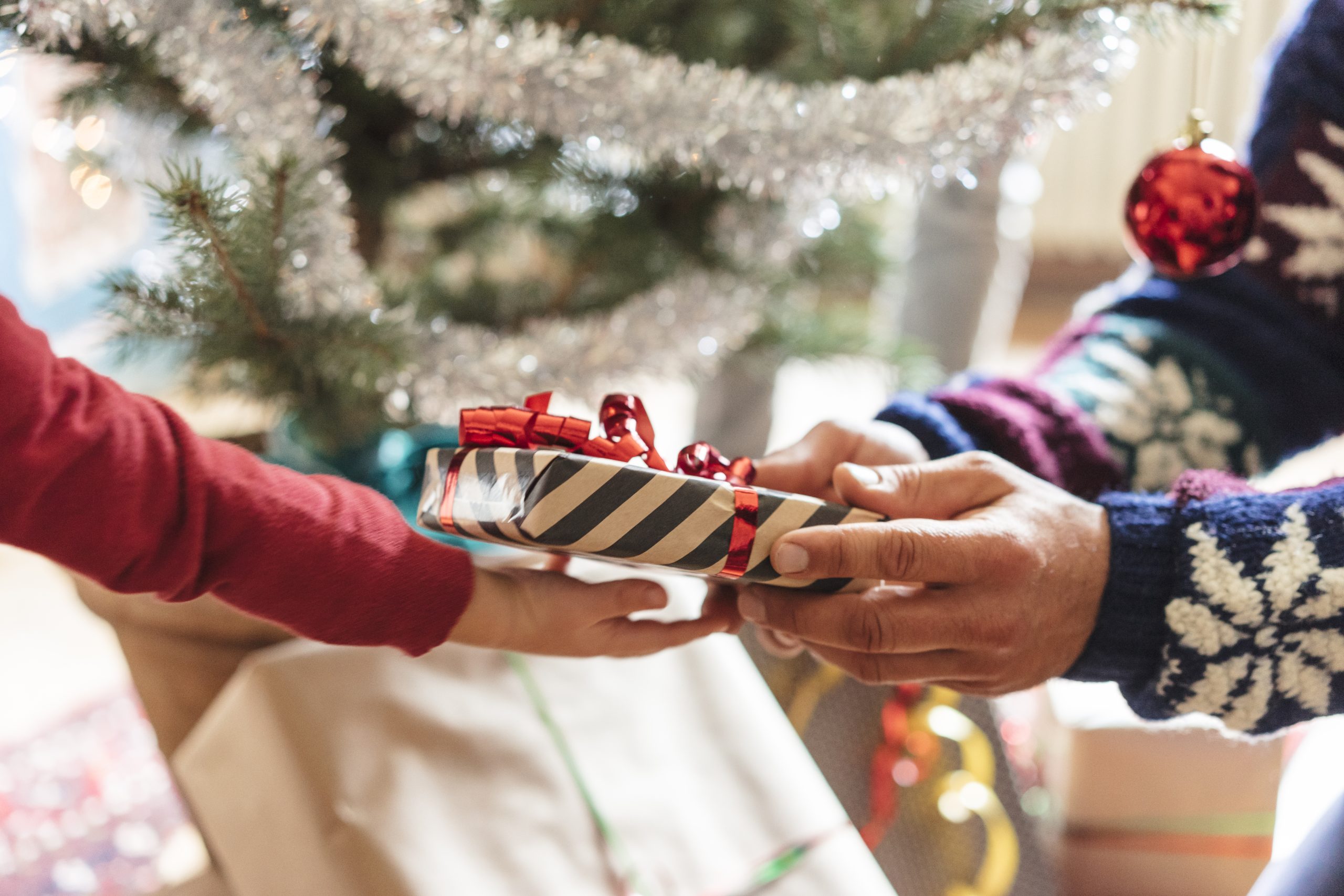 family at home sharing presents for christmas