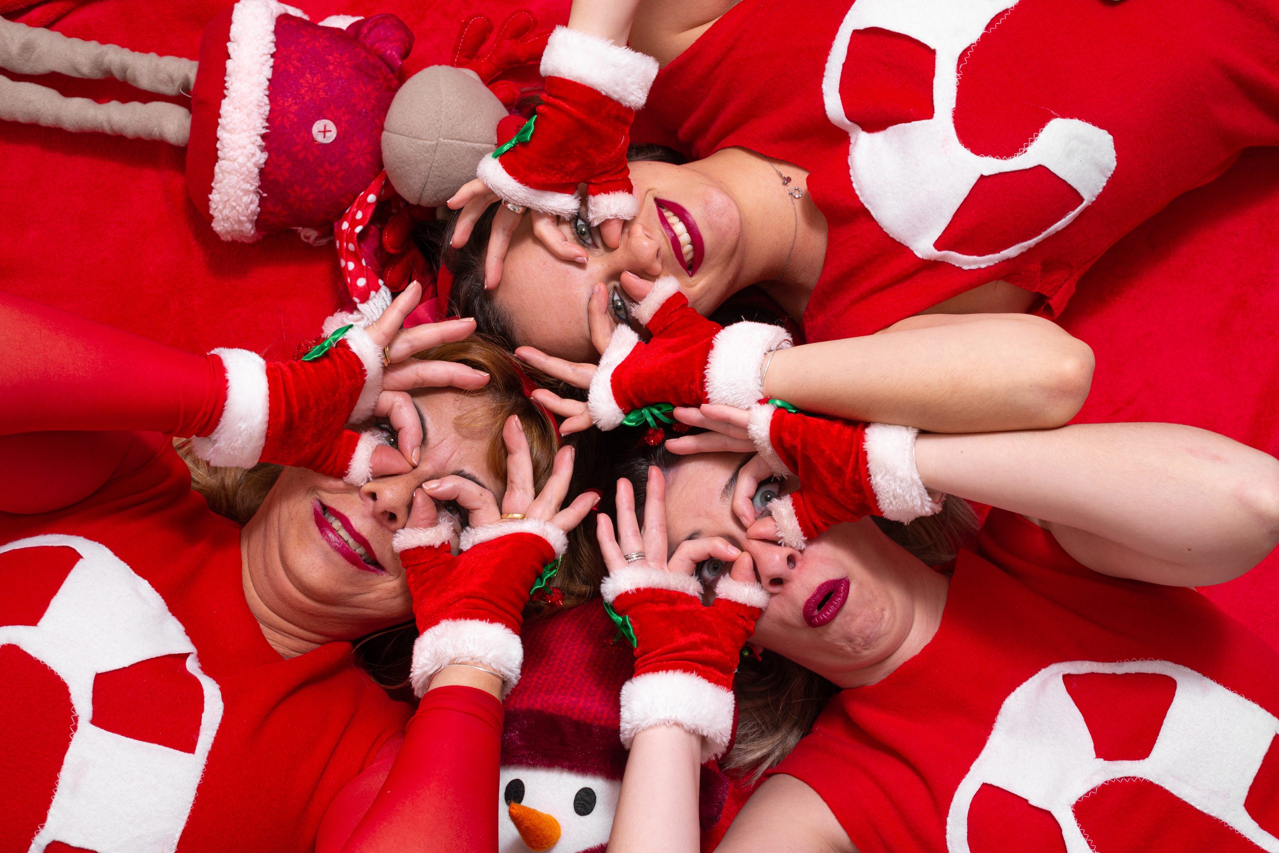 Portrait of three women making funny faces from above in christmas mood