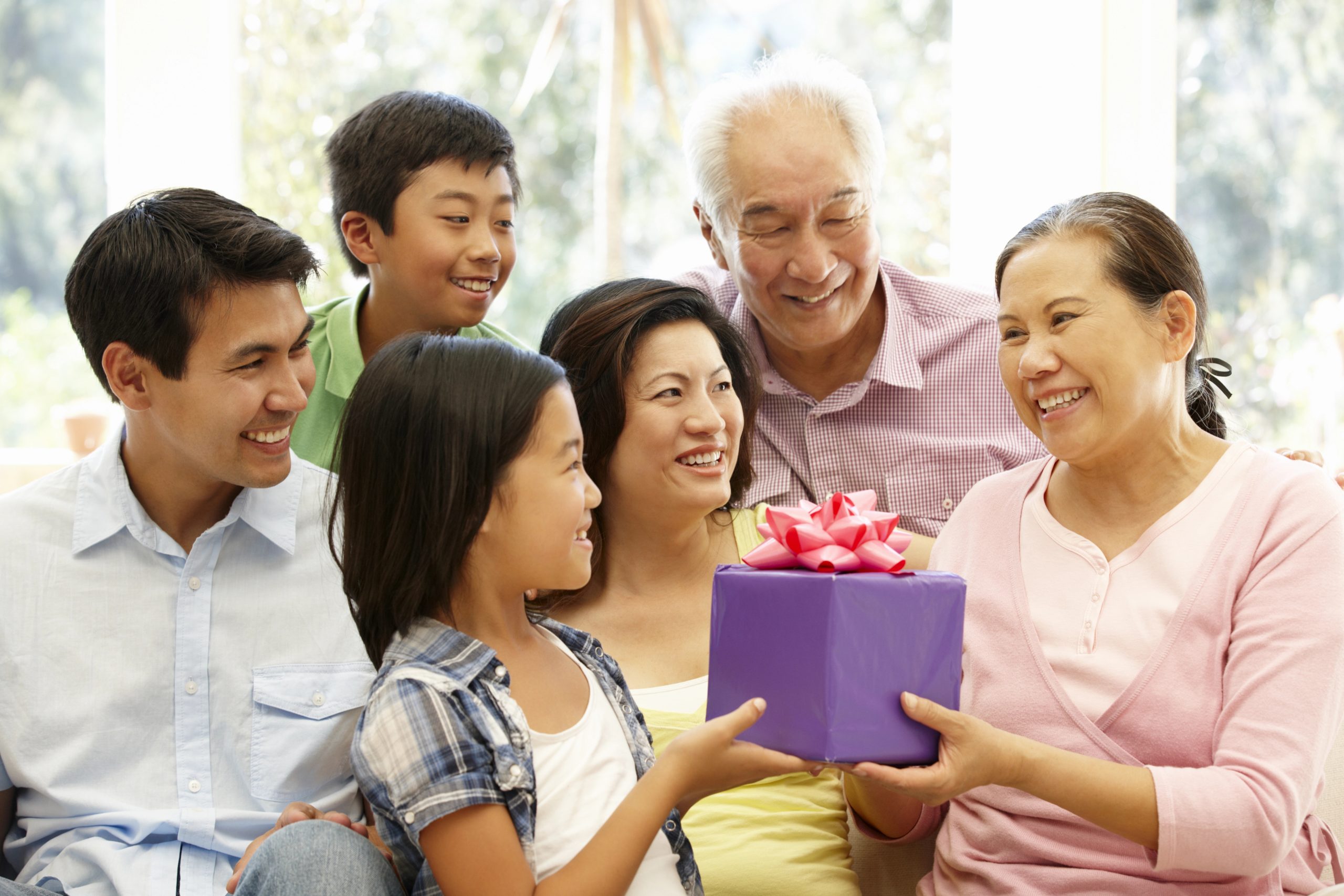 Family giving present to little girl