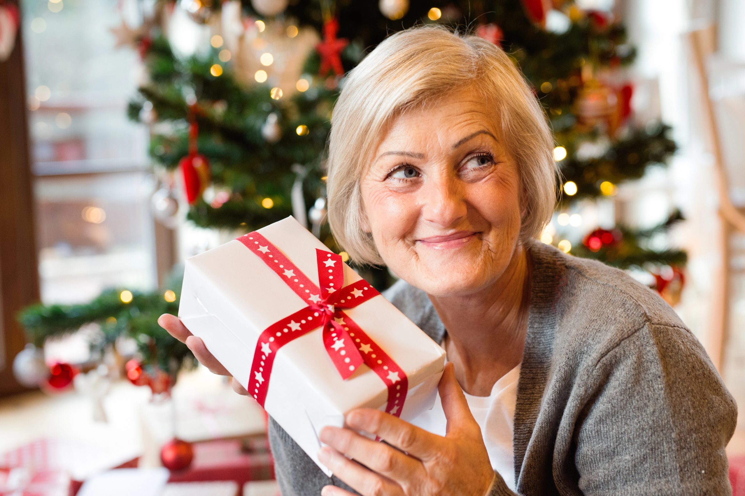 older mom smiling with christmas gift