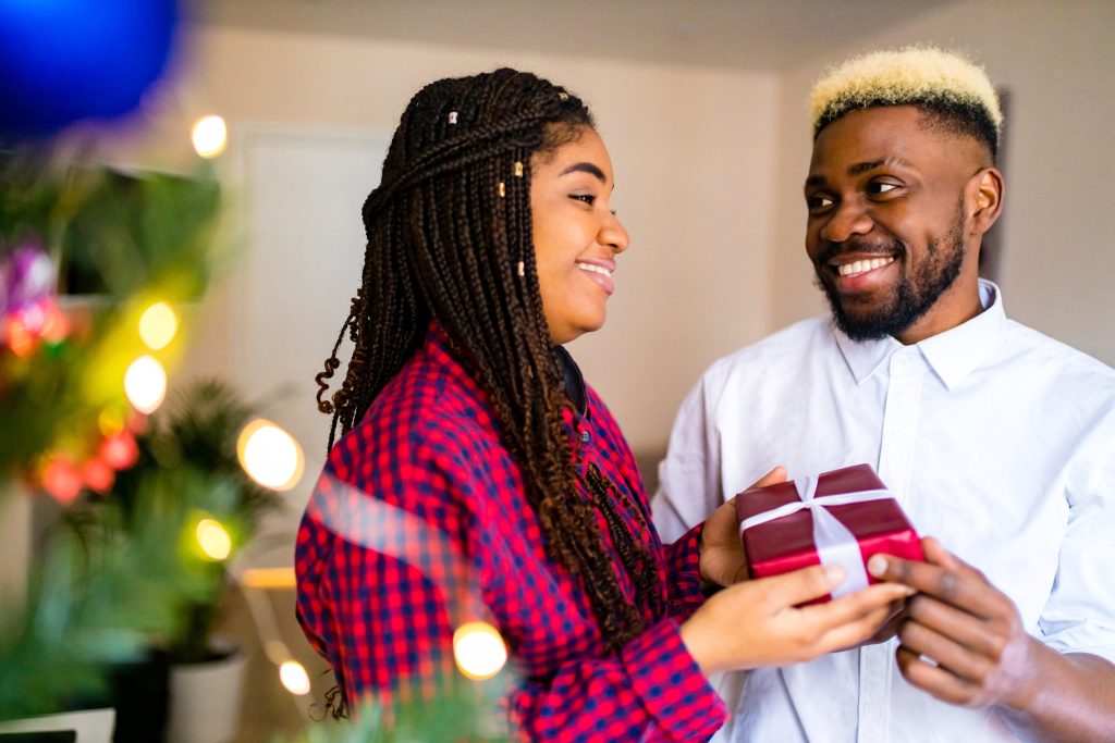 beautiful family holding gift box celebration xmas at home