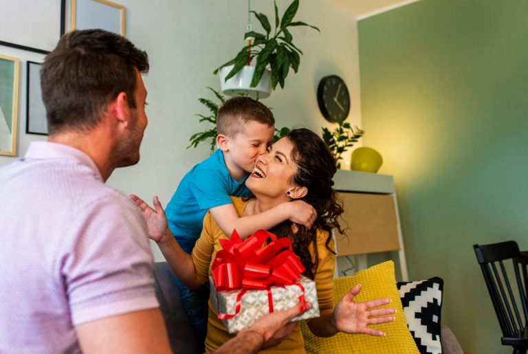 Father and son surprise mother with birthday present an home.