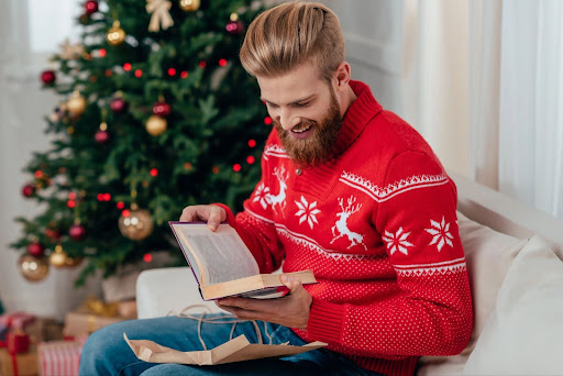 Man opening book gift on Christmas