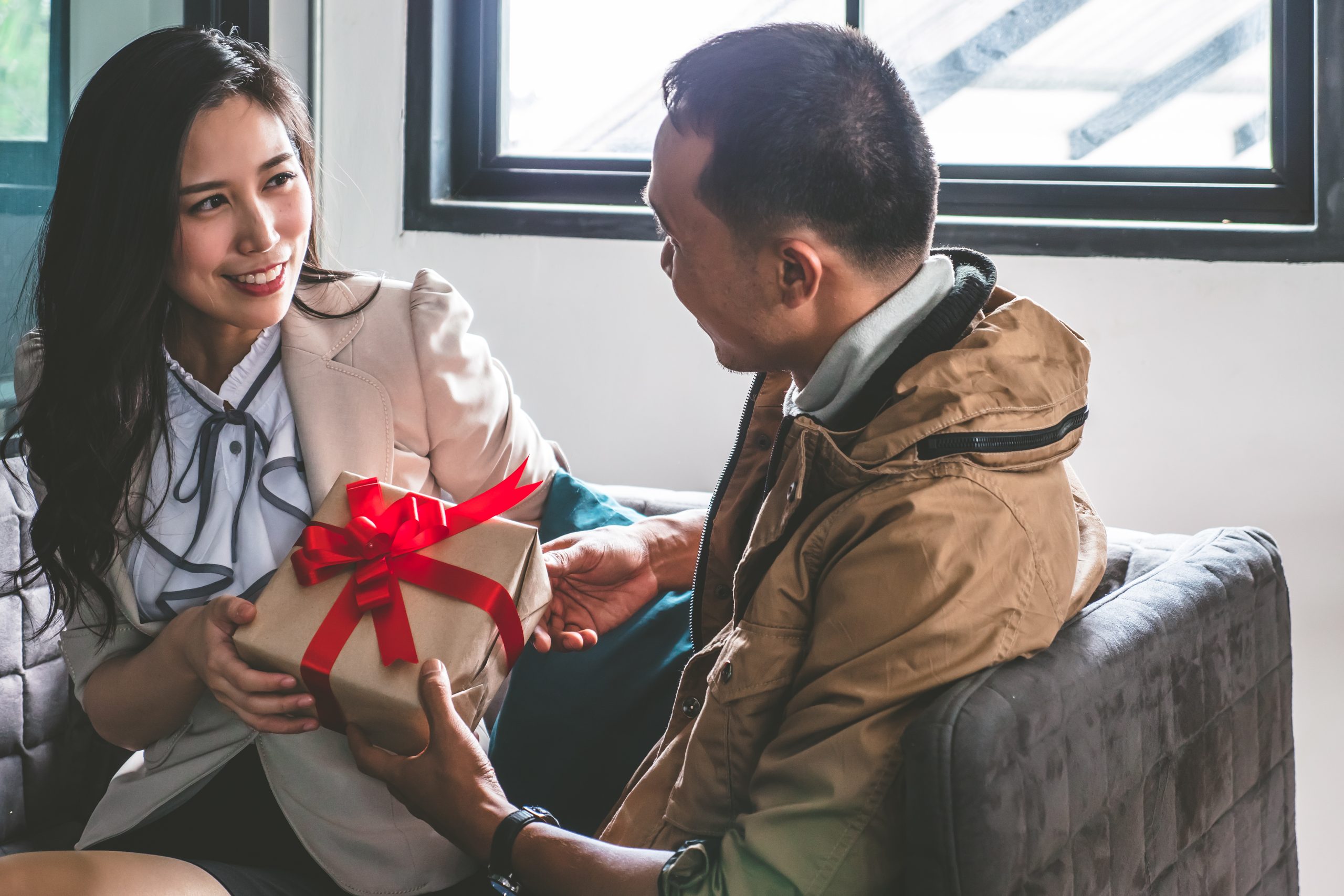 sister giving adult brother christmas gift