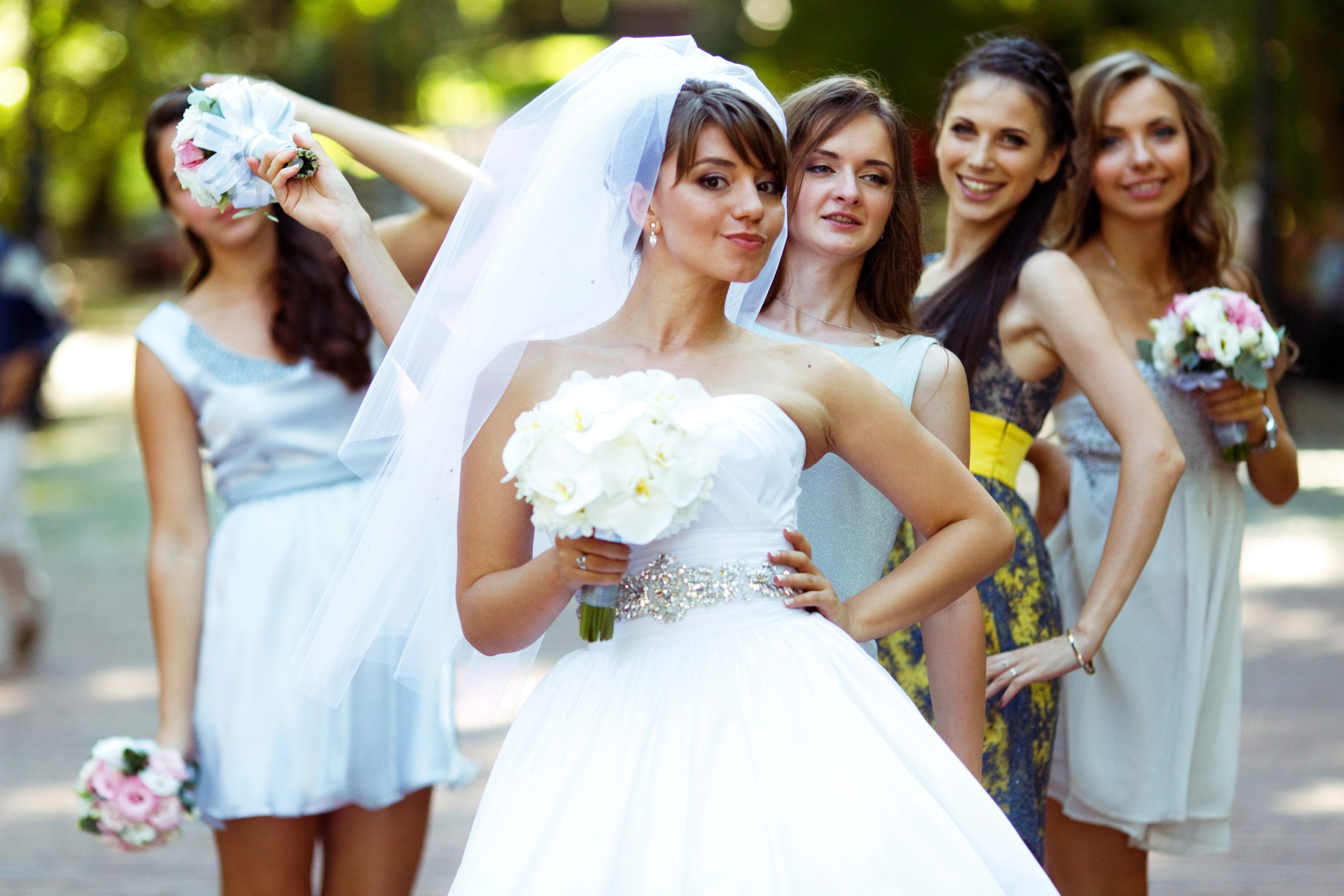 bride with bridesmaids wearing short wedding dress