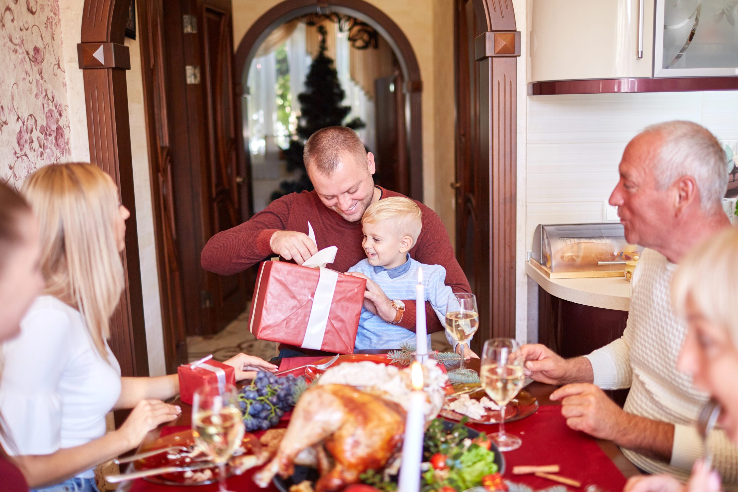 dad opening christmas gift with son
