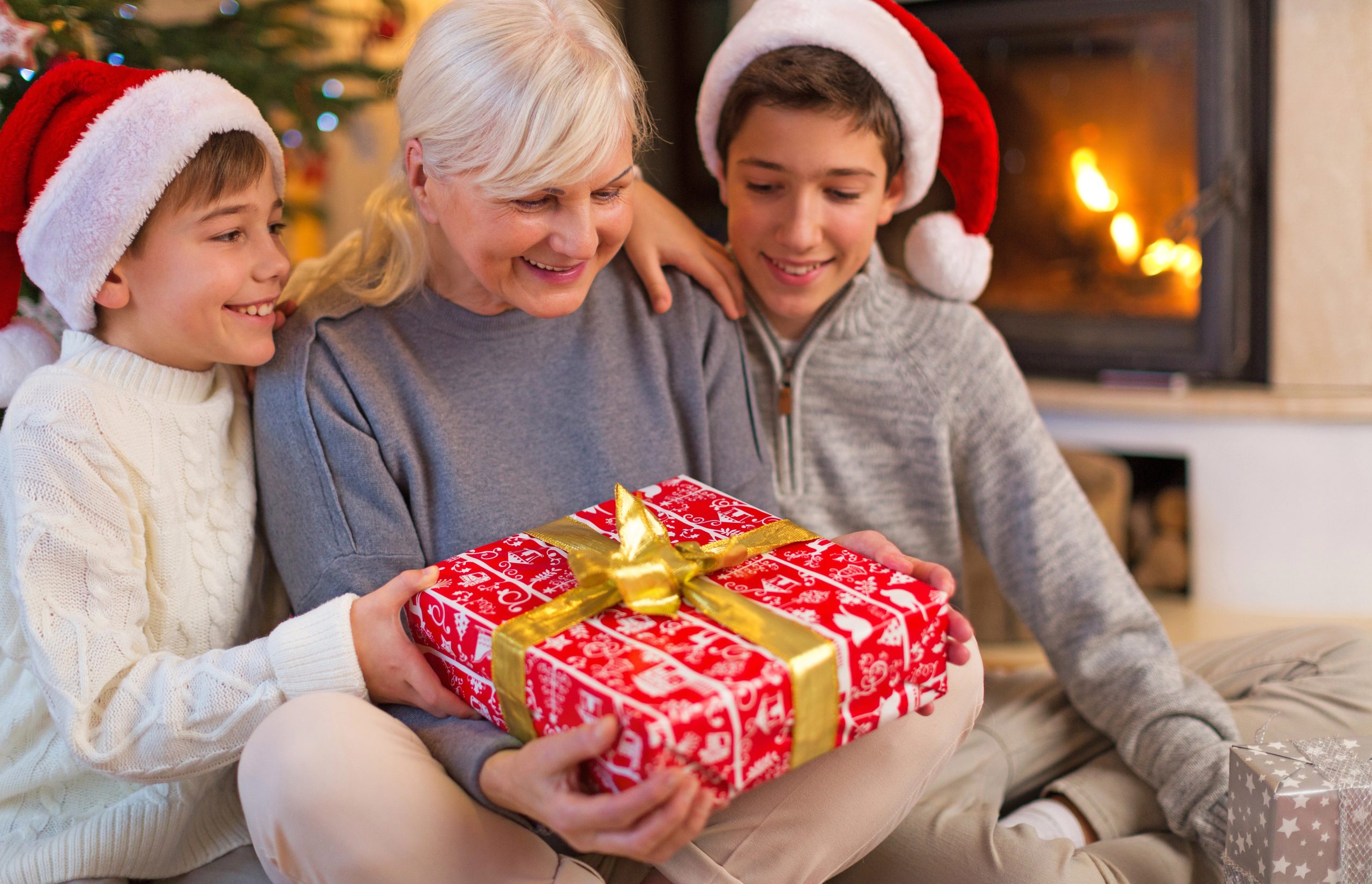 grandma smiling with christmas gift from grandson