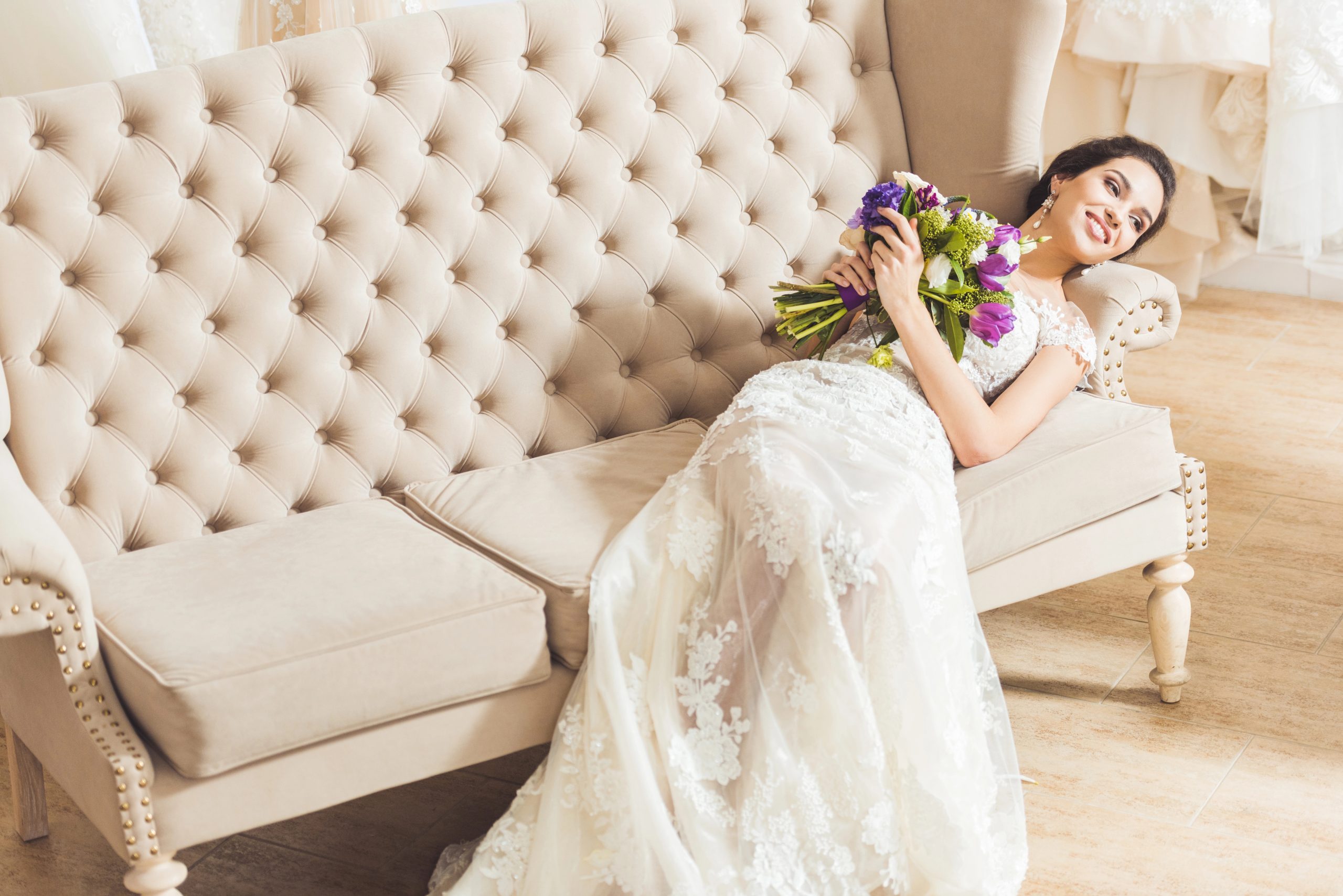 stylish photo of bride in white lace dress on couch