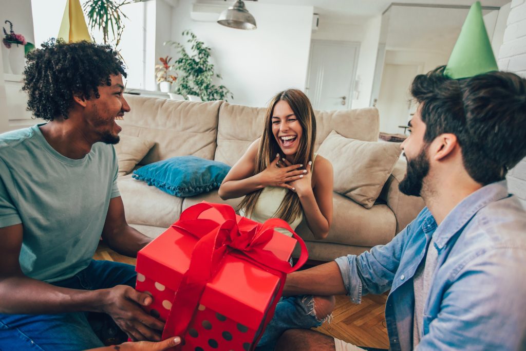 woman happy laughing with new christmas gift from friends