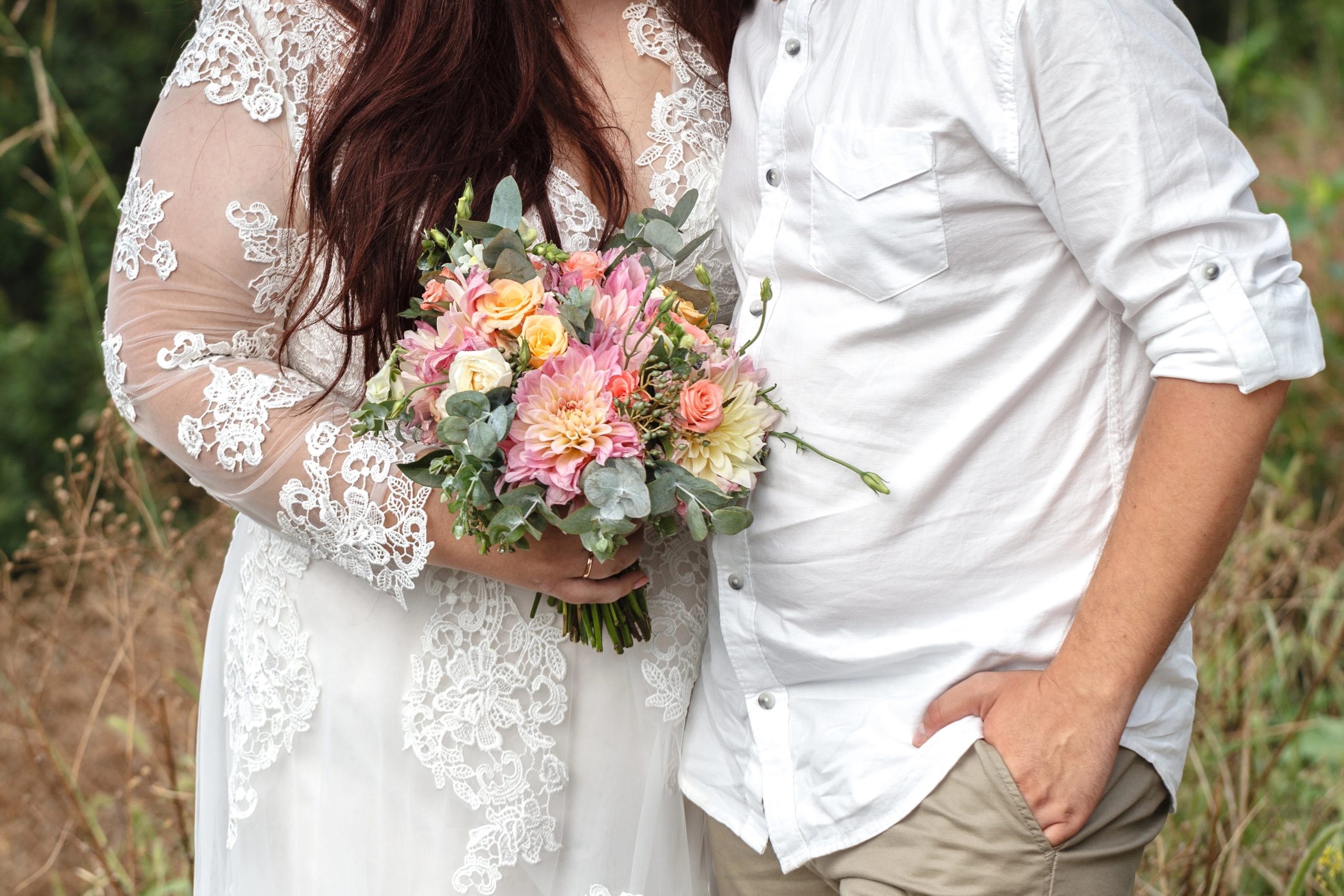 plus sized husband and wife wedding photo with flowers