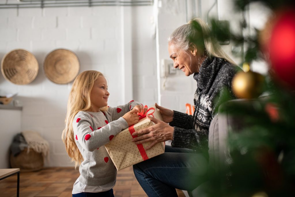 grandma getting gift from grand daughter