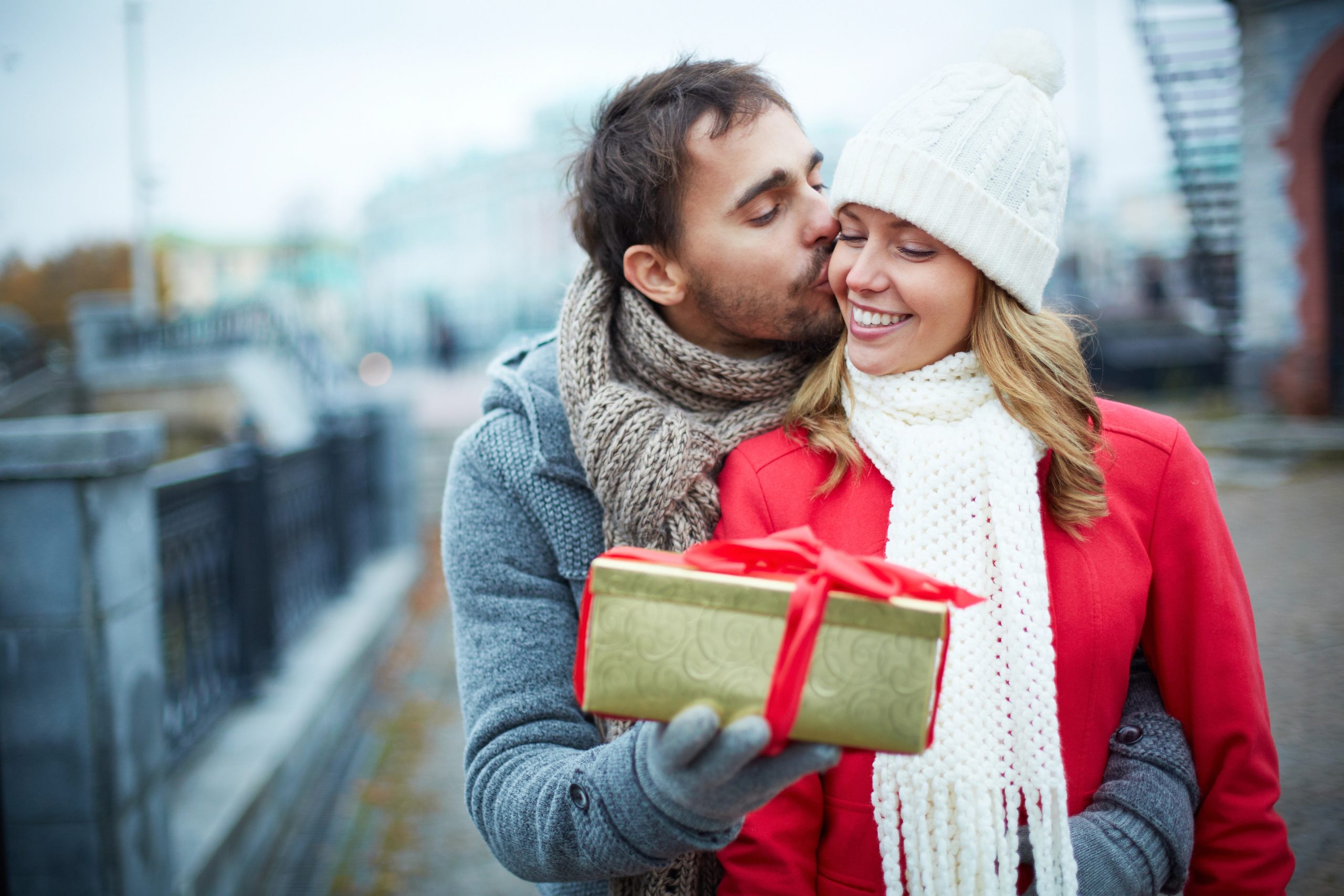 happy young couple with christmas gift