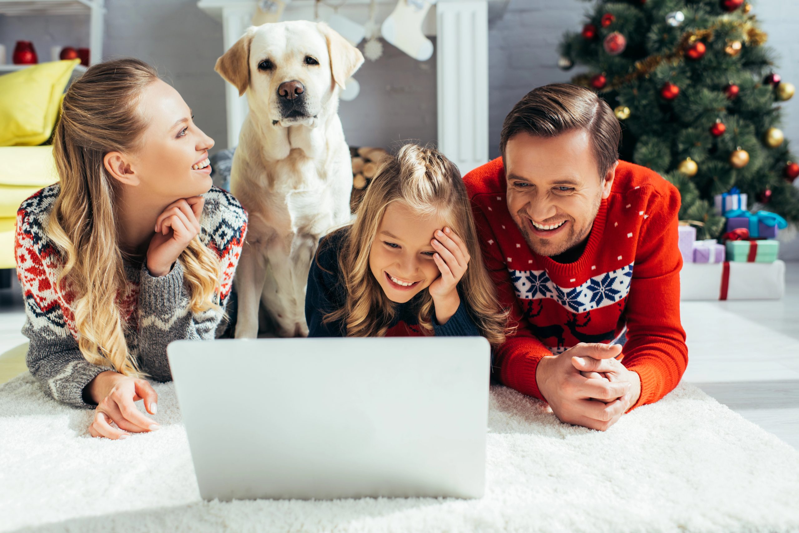 Happy family laughing at computer on christmas