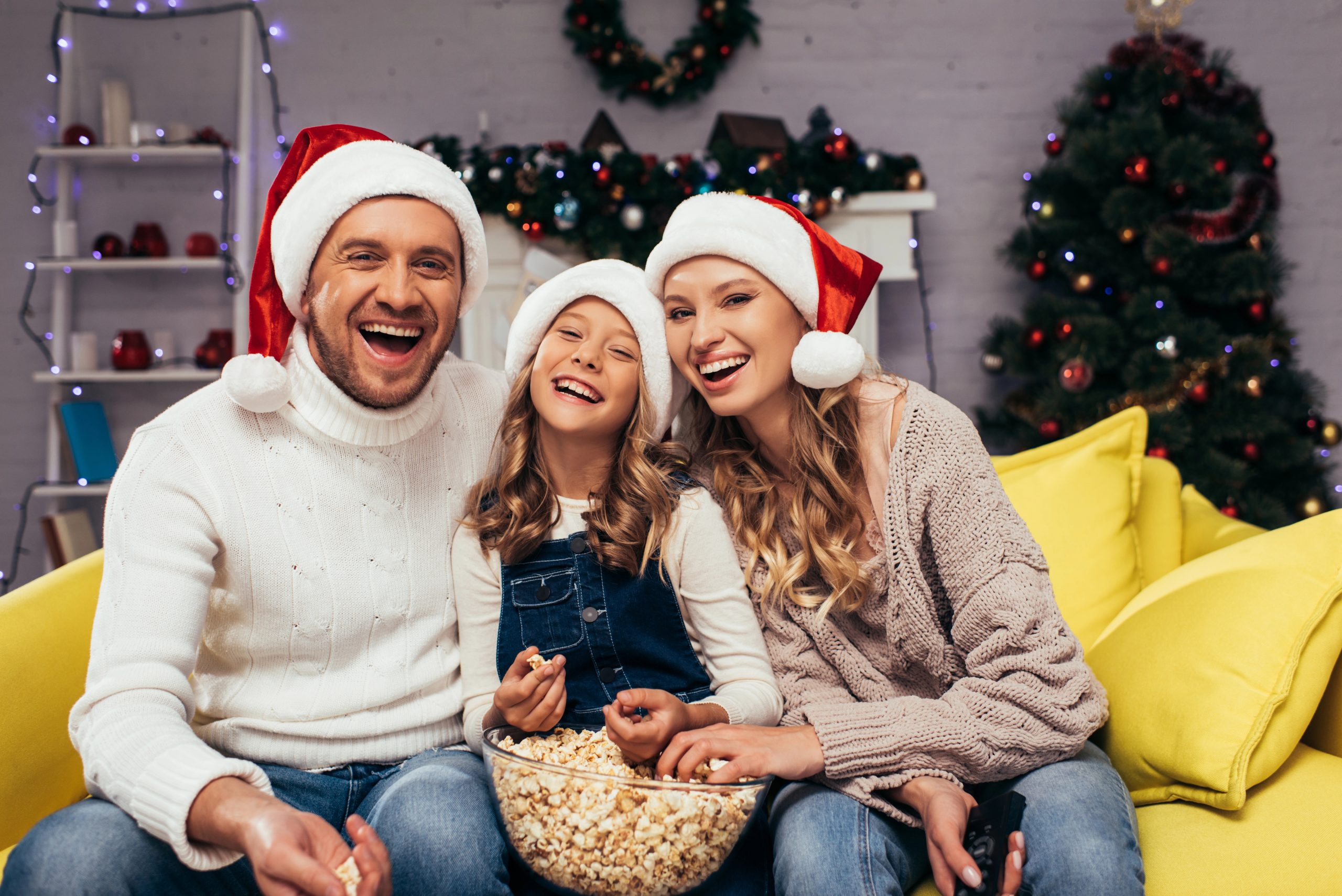 happy young family smiling laughing at christmas