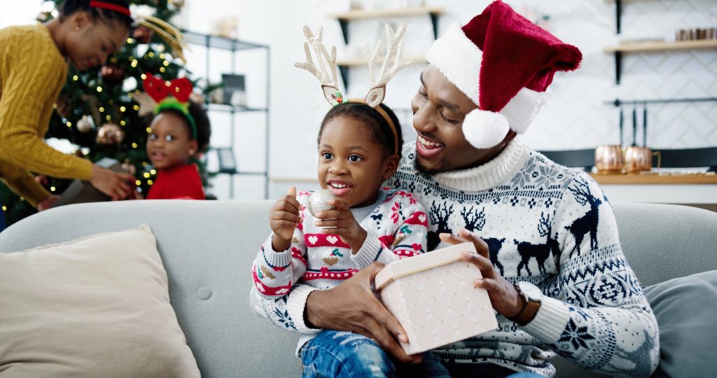 dad with santa hat on with son on lap