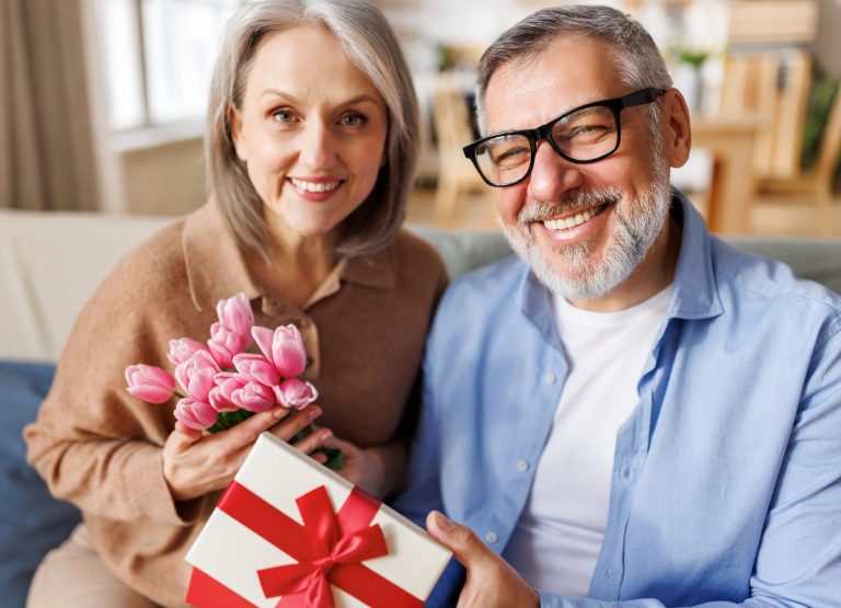 grandma and grandpa happy with christmas gift
