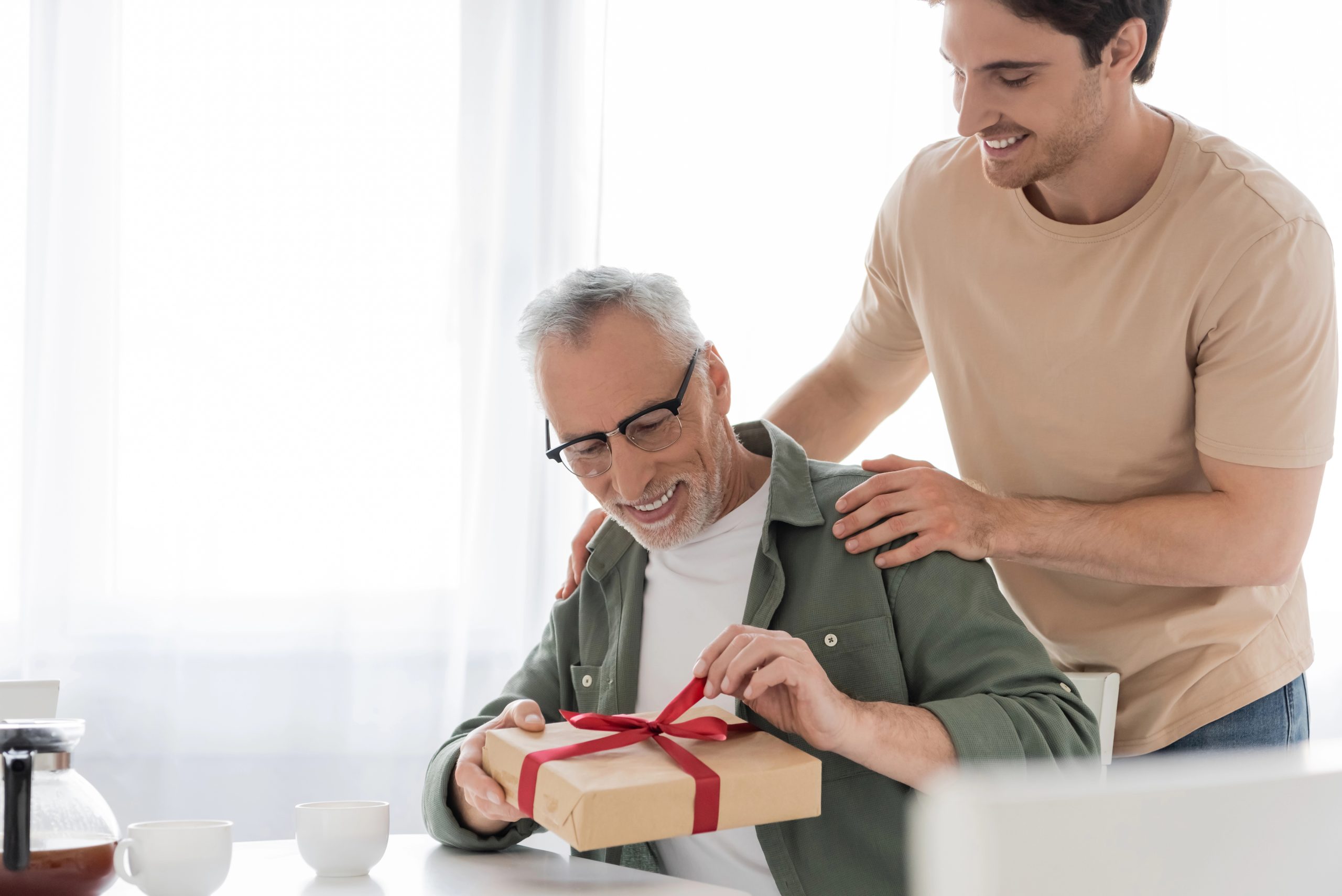 Older man getting gift from son
