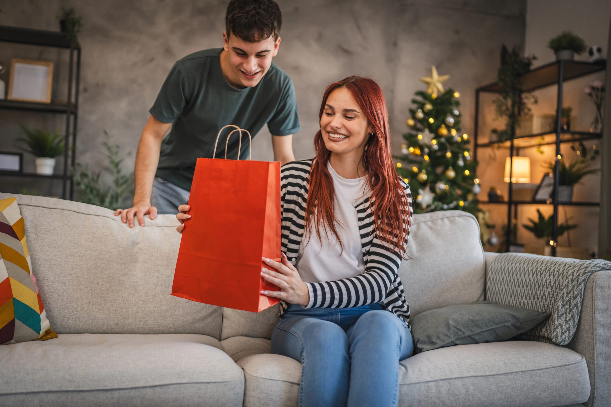 Young man giving gift to girl