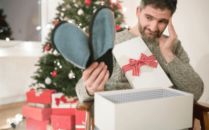 man disappointed with ugly christmas slippers