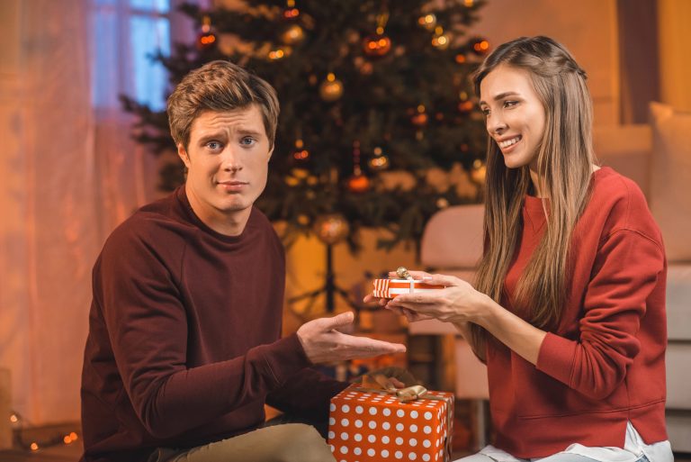 young couple opening a gift she didnt like