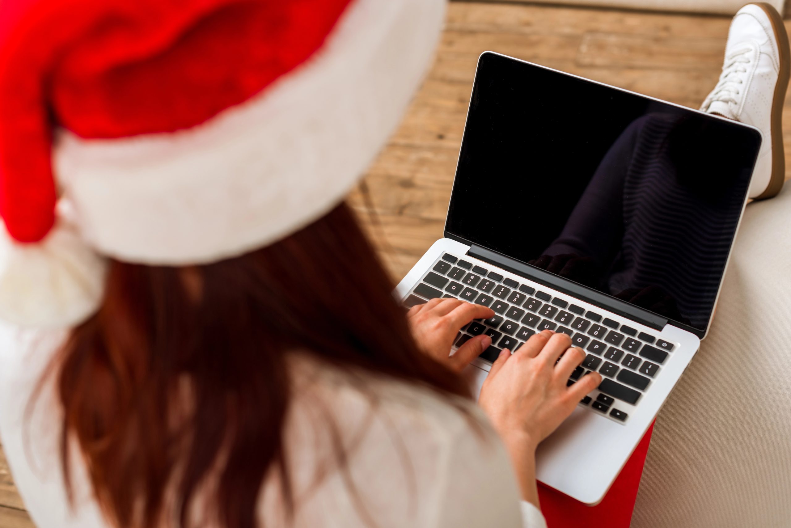 woman using computer to host virtual secret santa