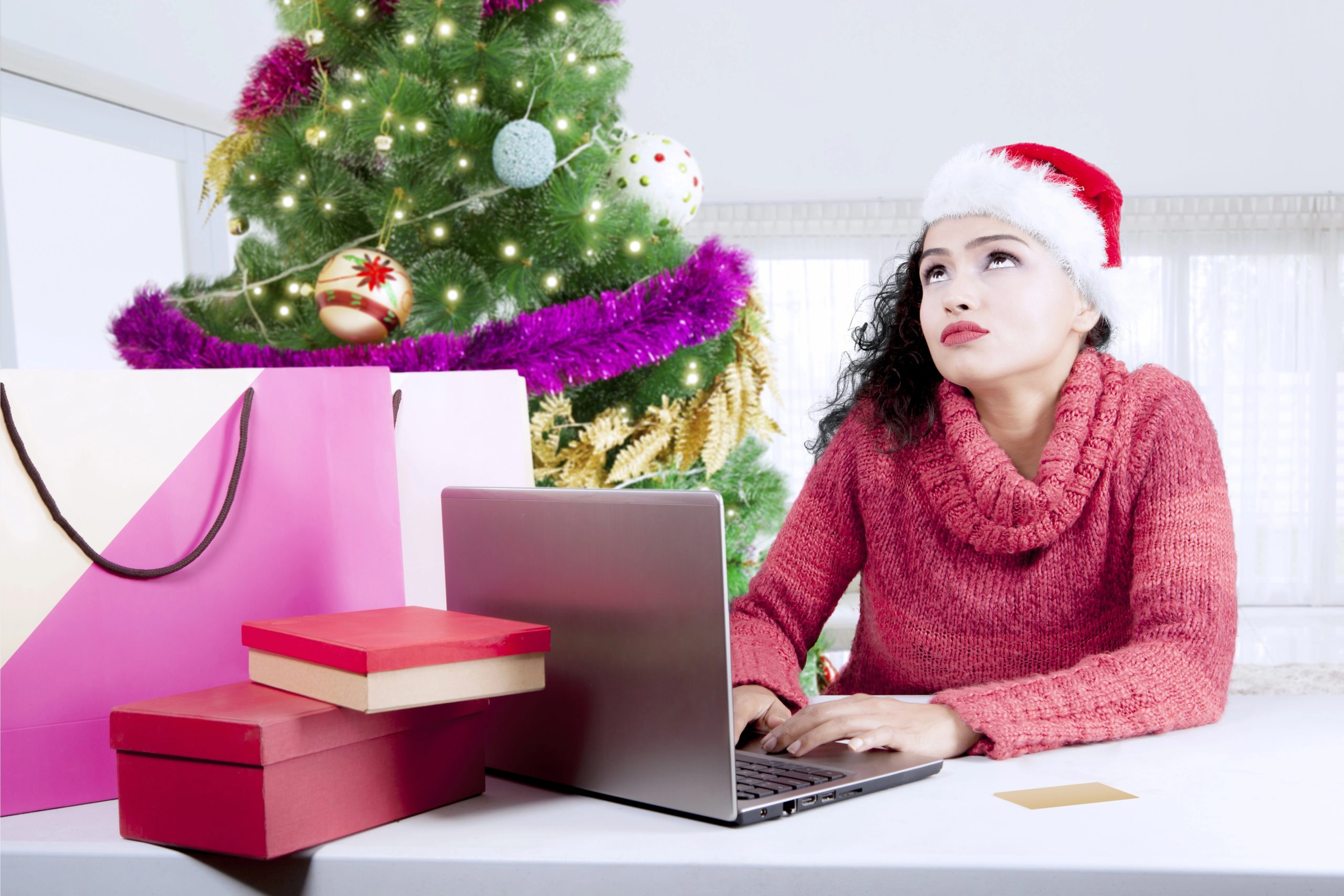 woman thinking creating gift registry on computer