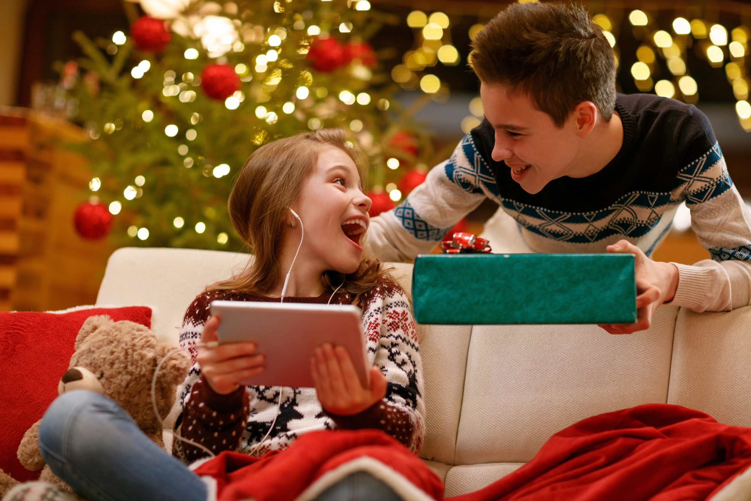brother giving young sister a gift