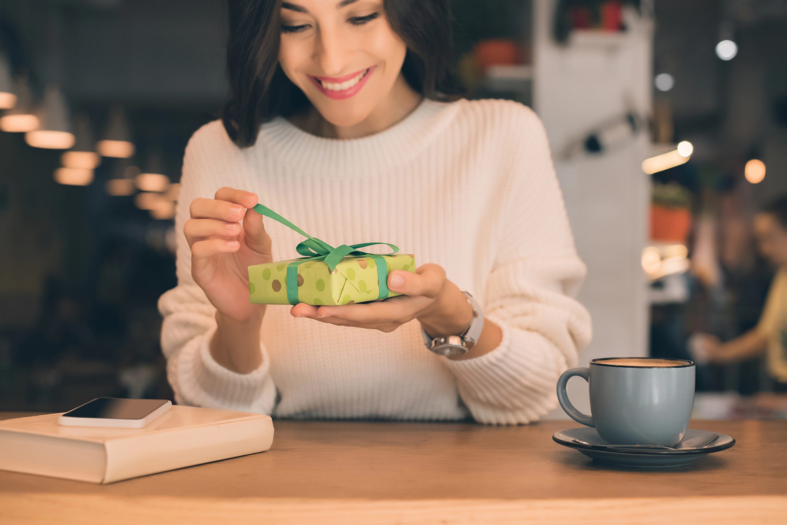 woman opening coffee gift