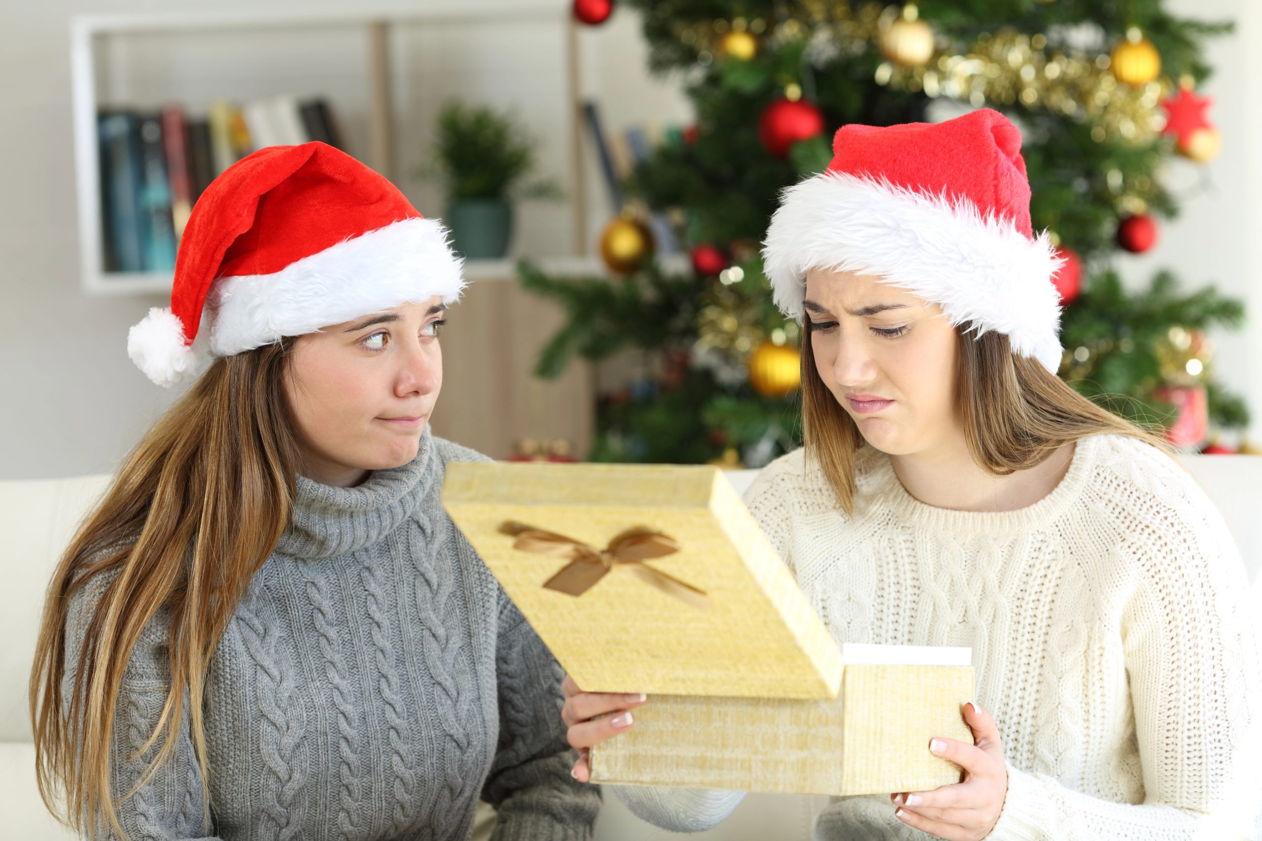 girl making ugly face expression when getting gift she didnt want