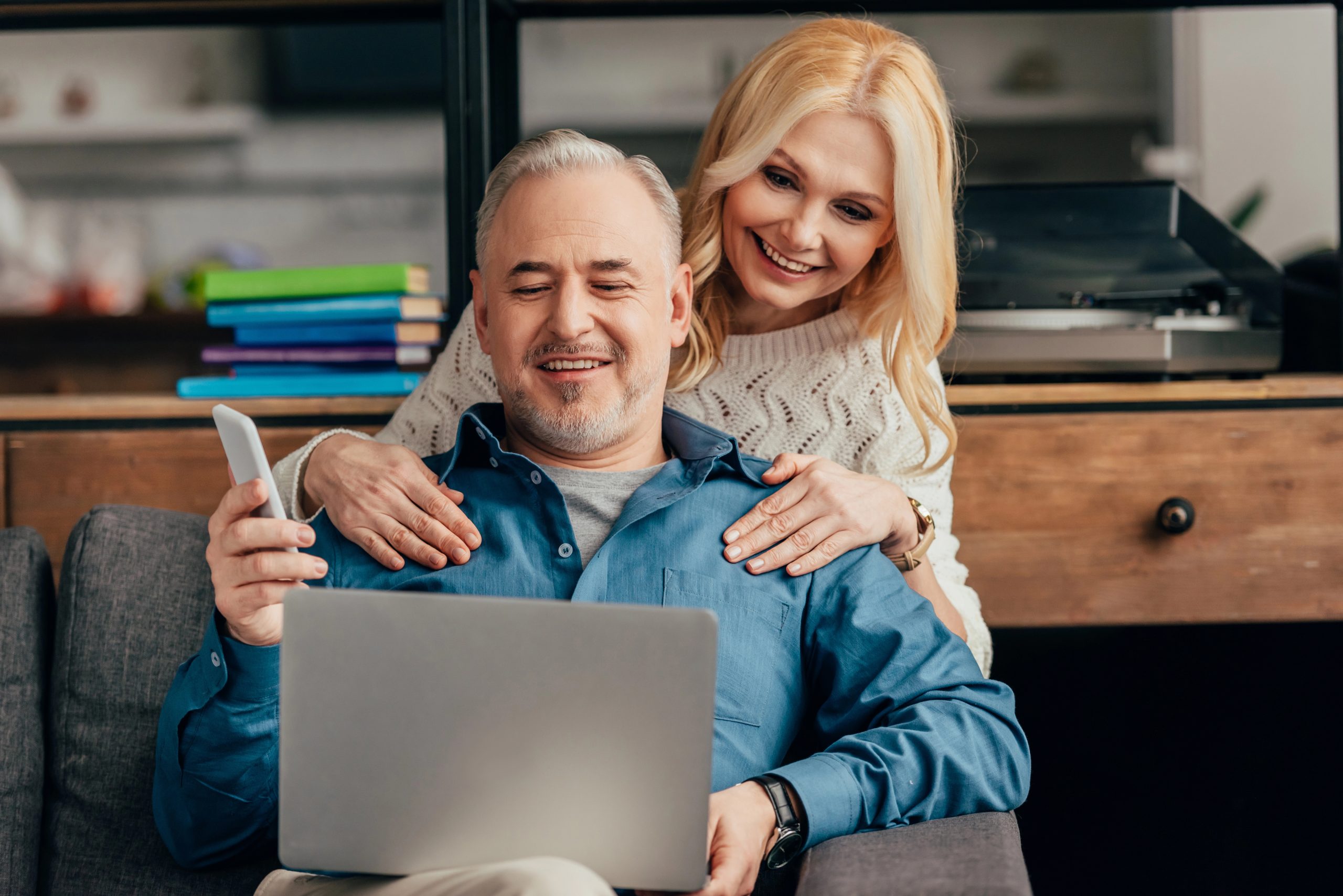older man and woman making gift list on computer