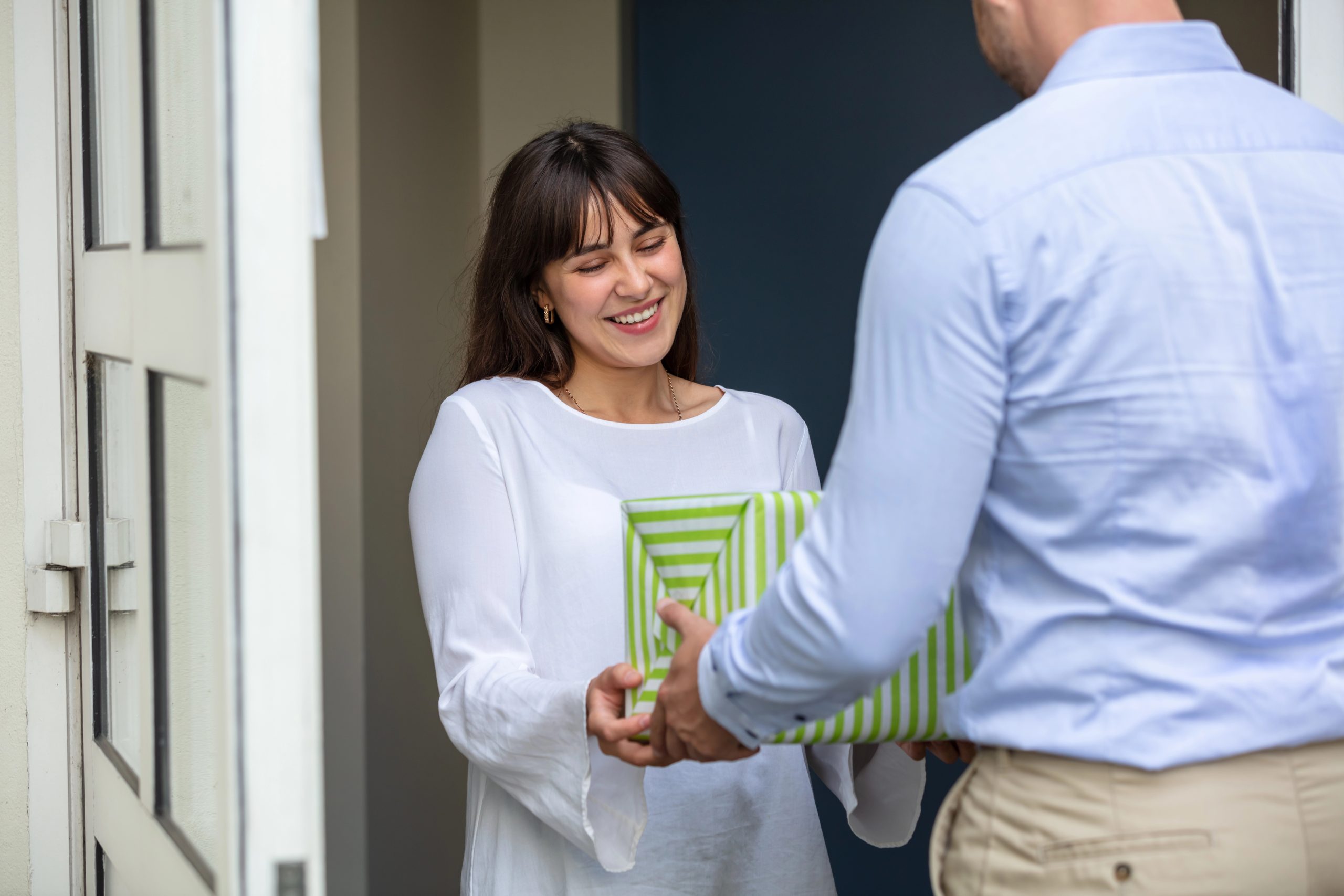 woman receiving thoughtful housewarming gift