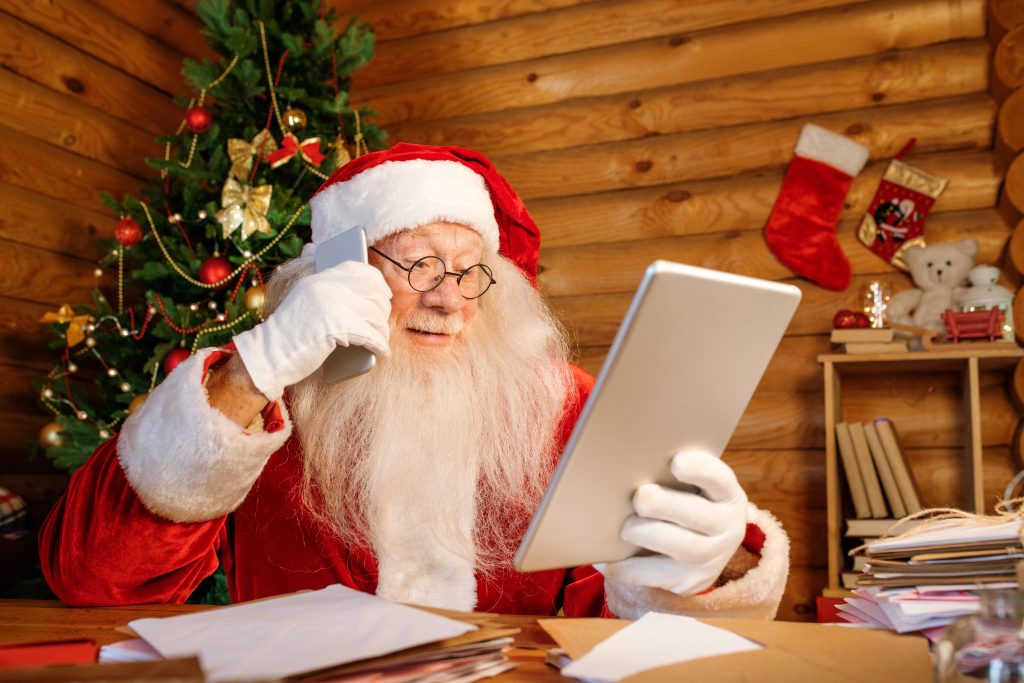 santa using gift list on ipad