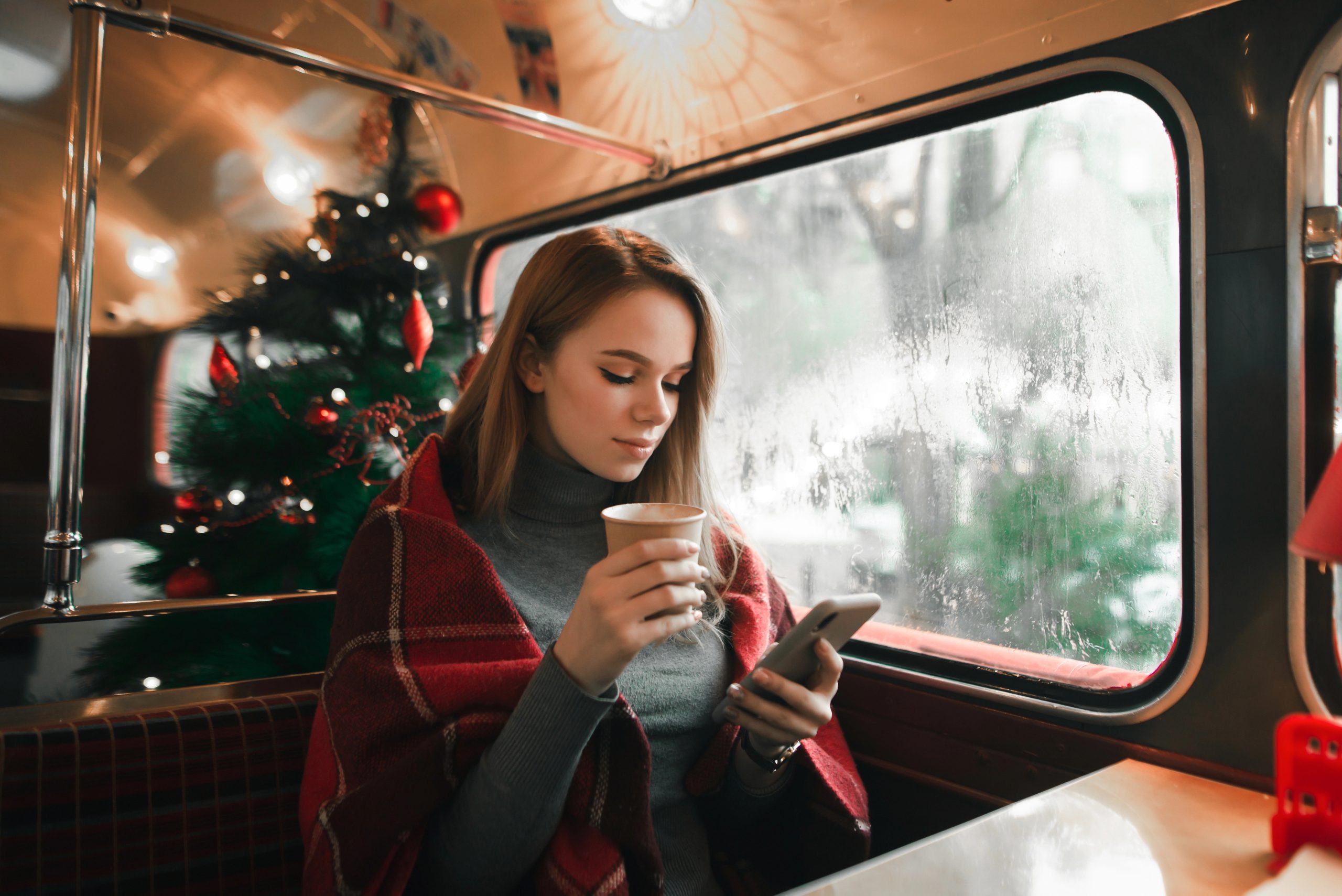 busy woman managing gift registry on public transport