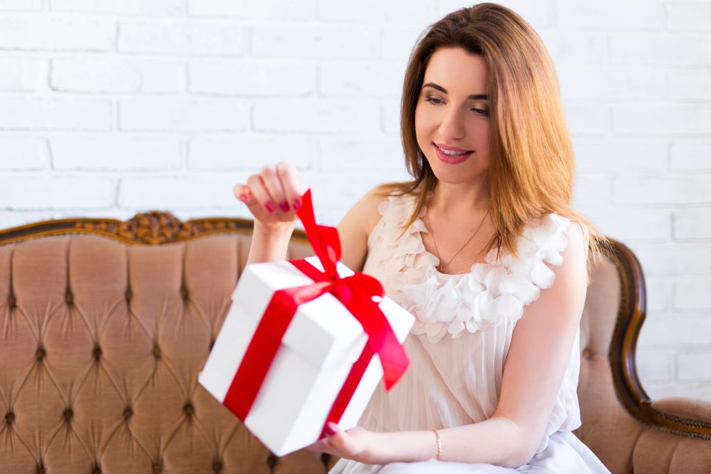 woman opening pretty gift box
