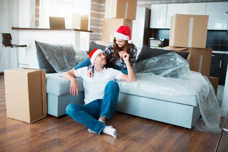young couple in new home for first christmas together