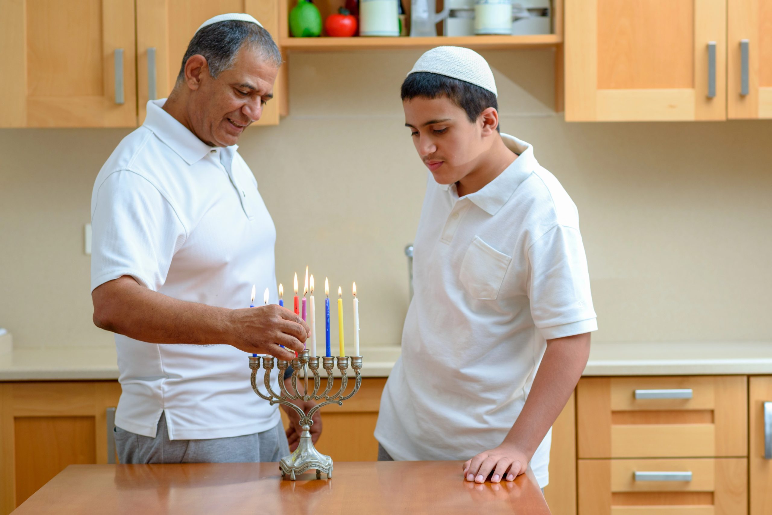happy father and son with hannukah candles