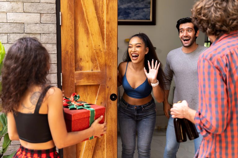 couple receiving housewarming party guests