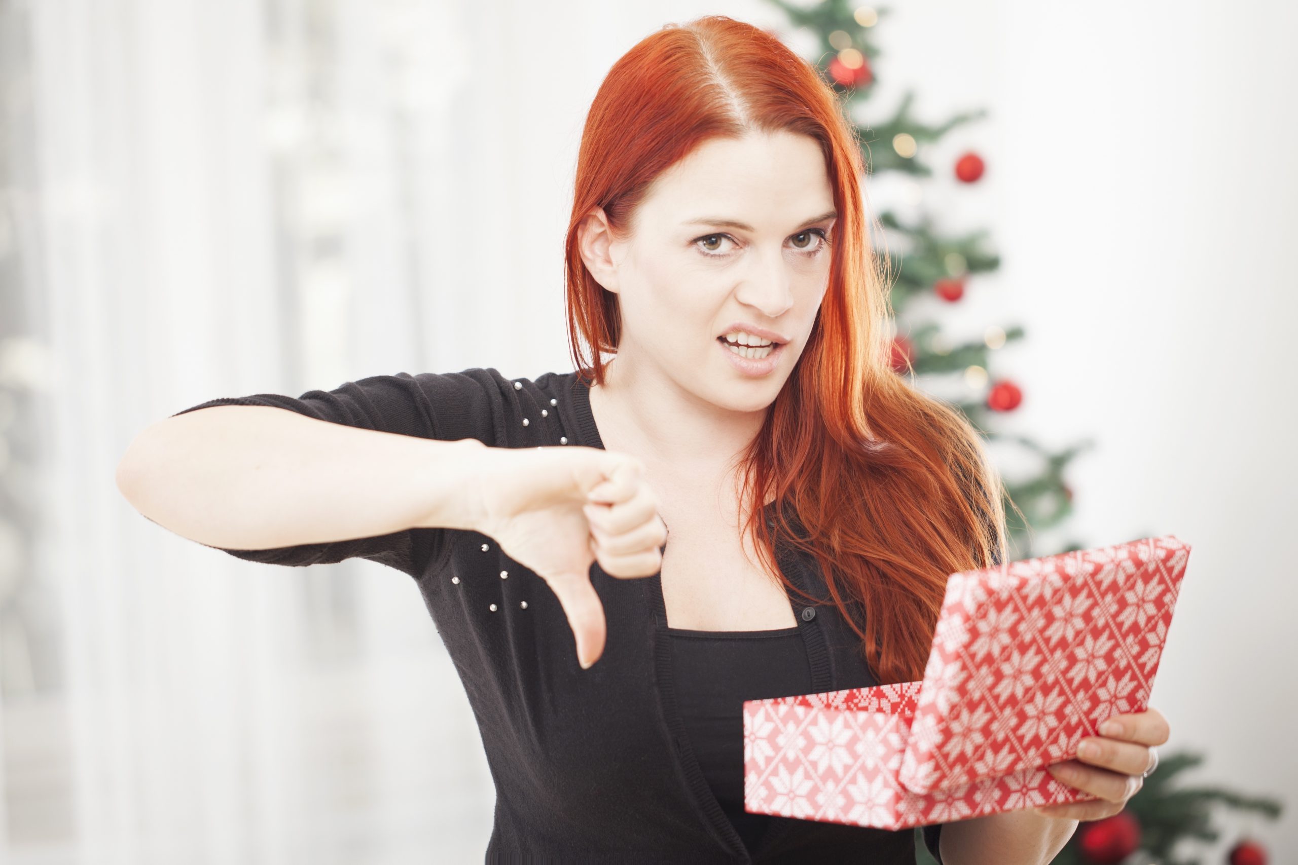 woman pointing thumbs down to ugly gift