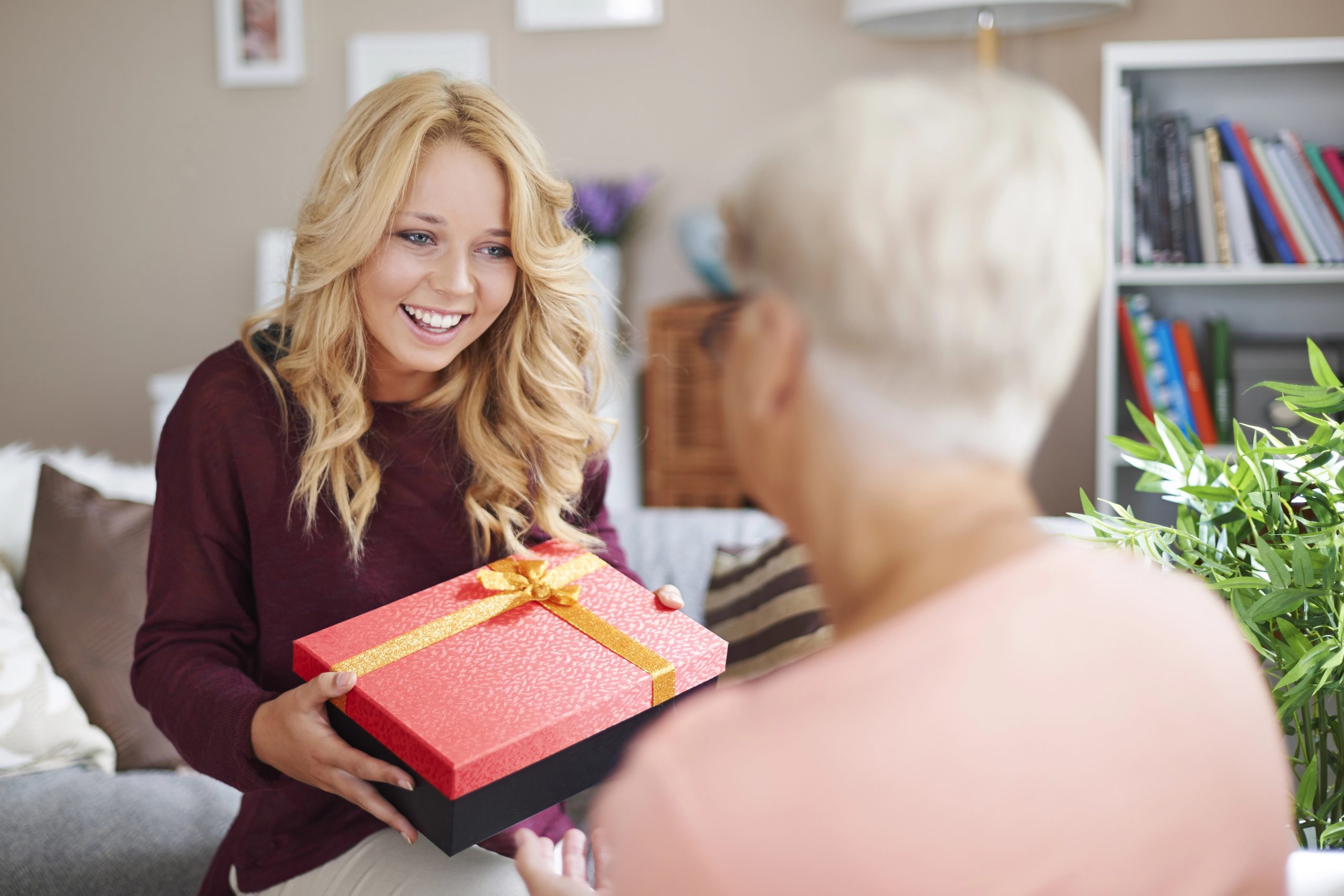 teenage girl getting gift from grandma