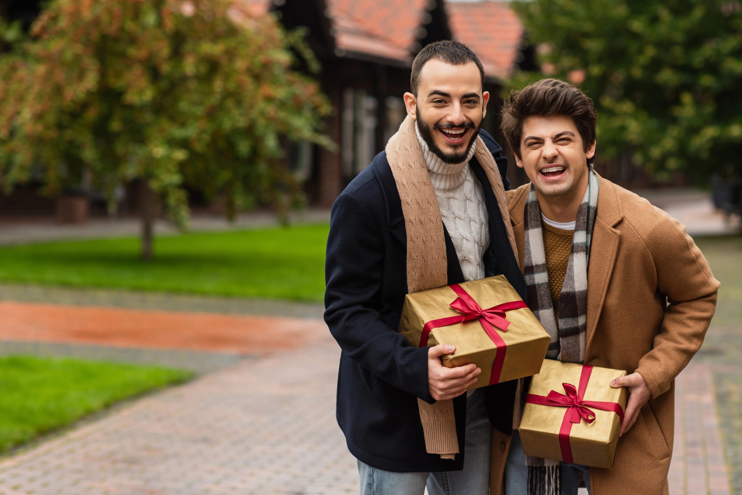 happy men with gifts for each other