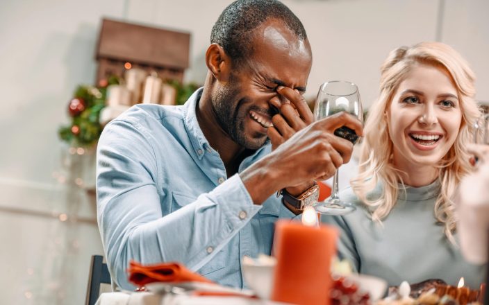 man laughing hysterically at christmas joke