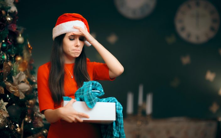 woman frowning with unwanted christmas gift
