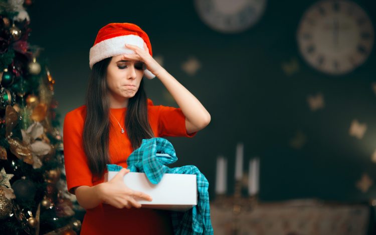 woman frowning with unwanted christmas gift