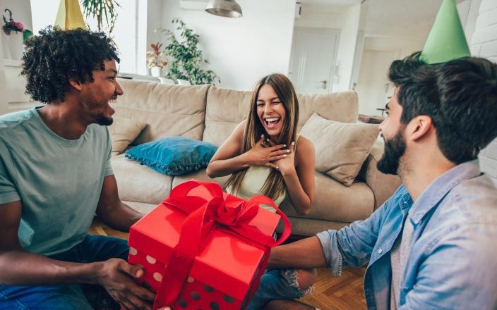 woman happy laughing with new christmas gift from friends