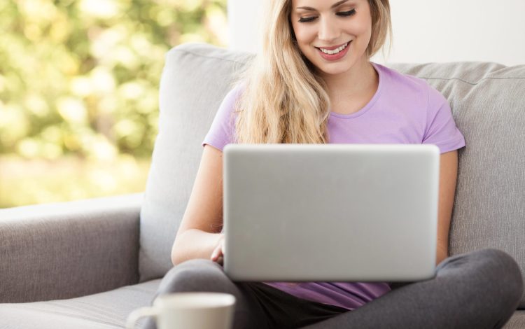 happy young woman reading on the computer