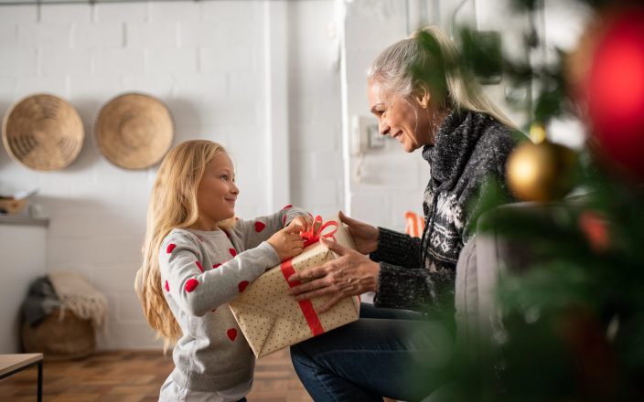 grandma getting gift from grand daughter