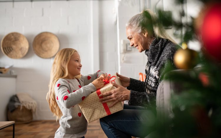 grandma getting gift from grand daughter