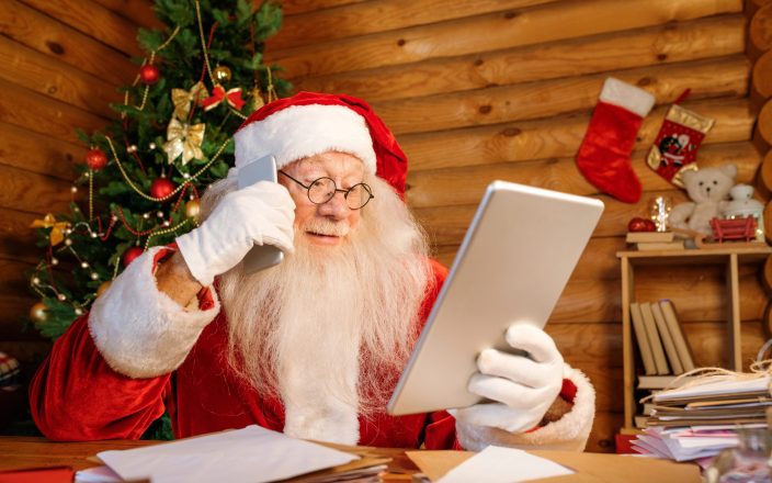 santa using gift list on ipad