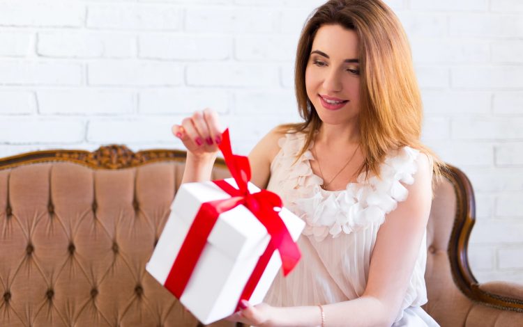 woman opening pretty gift box